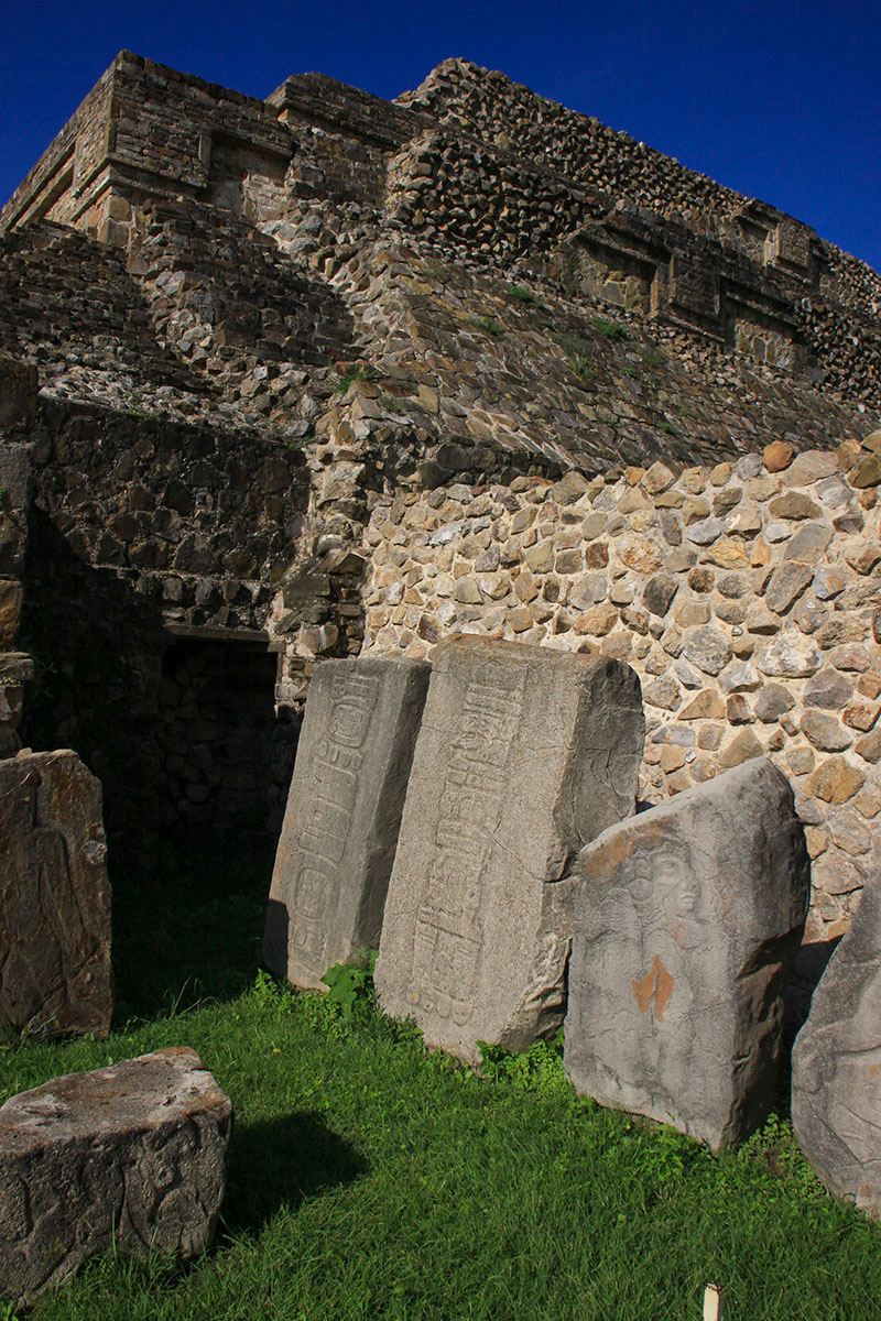 Carved stone slabs and the architecture behind them at Monte Albán, Oaxaca.