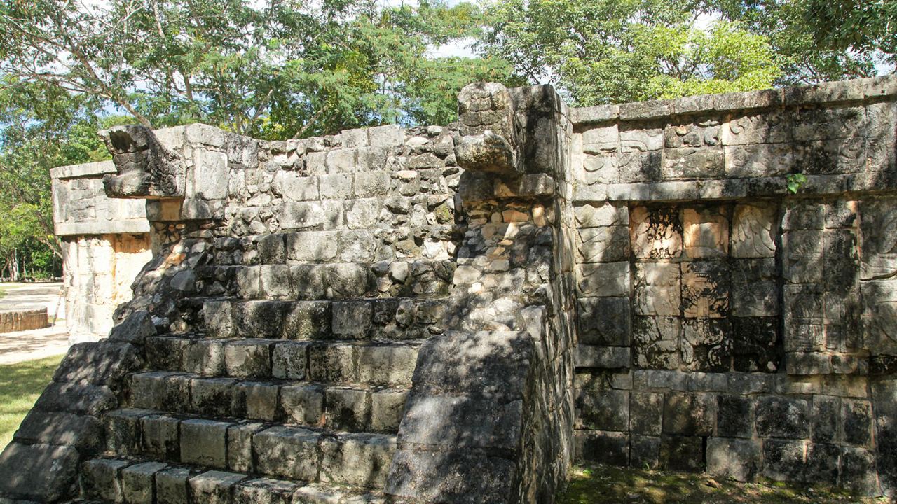 A stone staircase leads toward projecting forms and decorated masonry.
