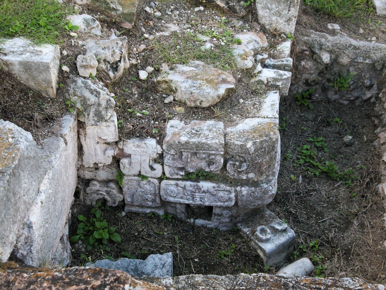 Carved surfaces among weathered stone blocks.